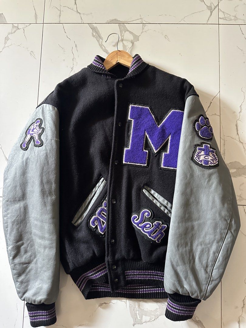 Millennium Tigers Vintage Leather Varsity Jacket (Category: Coats, Jackets and Outerwear) located in Manila. Submitted by daypuyarta27787 (Listing ID 1459039358, Image 1). Description: - Vintage Millennium Tigers varsity jacket - Black body with grey leather sleeves - Features 'M' patch on front - Tiger graphic on back - 'Seth' embroidered on front - Ribbed cuffs and collar - DM for details and price.