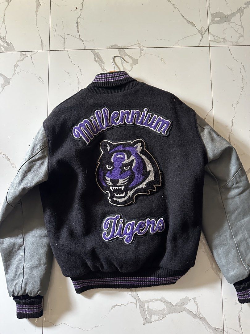 Millennium Tigers Vintage Leather Varsity Jacket (Category: Coats, Jackets and Outerwear) located in Manila. Submitted by daypuyarta27787 (Listing ID 1459039358, Image 2). Description: - Vintage Millennium Tigers varsity jacket - Black body with grey leather sleeves - Features 'M' patch on front - Tiger graphic on back - 'Seth' embroidered on front - Ribbed cuffs and collar - DM for details and price.
