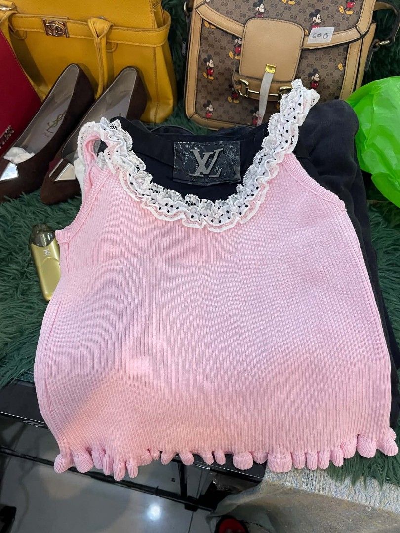 Miu Miu Pink Ruffled Crop Top (Category: Others Tops) located in Cainta. Submitted by mariss.luxx (Listing ID 1459007110, Image 2). Description: - Adorable pink Miu Miu crop top - Features charming ruffles and polka dots - Made from comfortable ribbed material - Stylish lettuce hem detail - Ideal for creating cute summer outfits - Versatile for pairing with jeans or skirts.