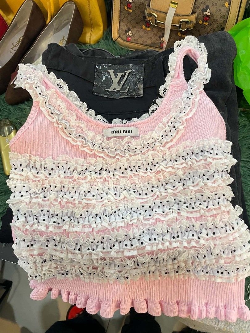 Miu Miu Pink Ruffled Crop Top (Category: Others Tops) located in Cainta. Submitted by mariss.luxx (Listing ID 1459007110, Image 1). Description: - Adorable pink Miu Miu crop top - Features charming ruffles and polka dots - Made from comfortable ribbed material - Stylish lettuce hem detail - Ideal for creating cute summer outfits - Versatile for pairing with jeans or skirts.