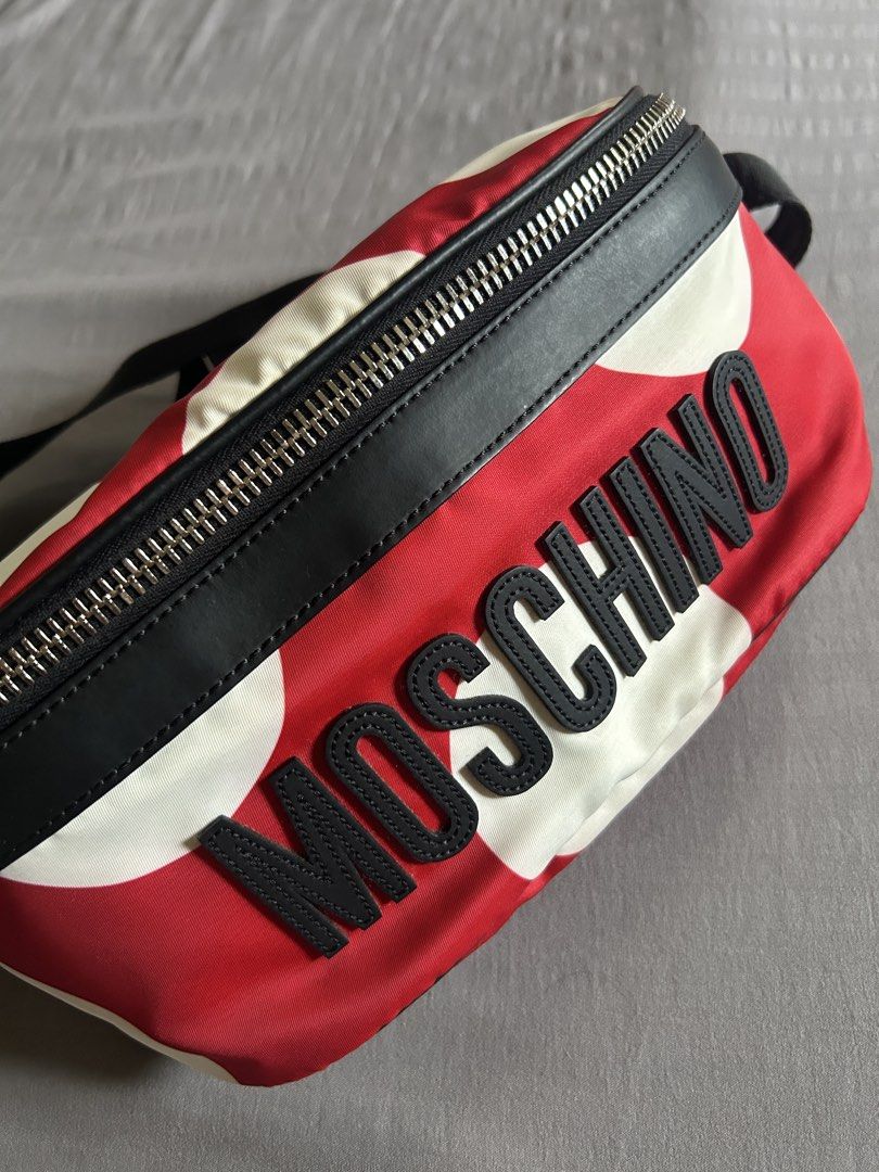 (Authentic) Moschino Red Polka Dot Belt Bag (Category: Luxury Bags & Wallets) located in Carigara. Submitted by abiesclutter (Listing ID 1458934079, Image 1). Description: - Moschino belt bag - Black leather (Calf Skin) trim with red and white polka dots - "MOSCHINO" lettering - Silver hardware and zipper - Adjustable strap - Includes dust bag and authenticity cards - Made in Italy - CERTILOGO AUTHENTICATED with seal.