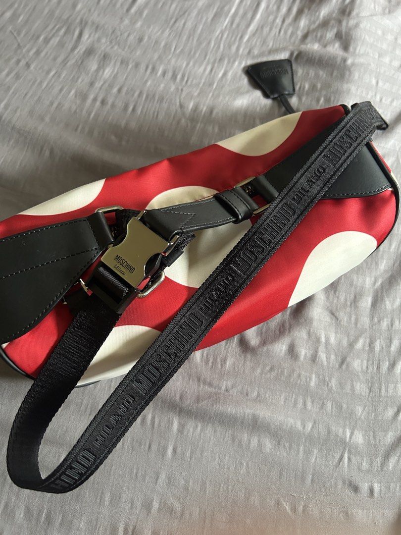 (Authentic) Moschino Red Polka Dot Belt Bag (Category: Luxury Bags & Wallets) located in Carigara. Submitted by abiesclutter (Listing ID 1458934079, Image 3). Description: - Moschino belt bag - Black leather (Calf Skin) trim with red and white polka dots - "MOSCHINO" lettering - Silver hardware and zipper - Adjustable strap - Includes dust bag and authenticity cards - Made in Italy - CERTILOGO AUTHENTICATED with seal.
