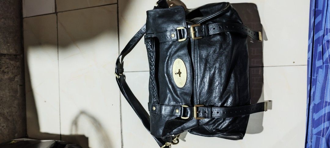 Mulberry Black Leather Backpack with Gold Hardware (Category: Backpacks) located in Paranaque City. Submitted by poego (Listing ID 1458949593, Image 1). Description: - Genuine Mulberry black leather backpack - Signature Postman's Lock closure - Adjustable straps for comfort - Interior zip pocket for essentials - Lined with classic Mulberry tree logo - Minor signs of wear on hardware and leather, adding character - Spacious interior, perfect for d