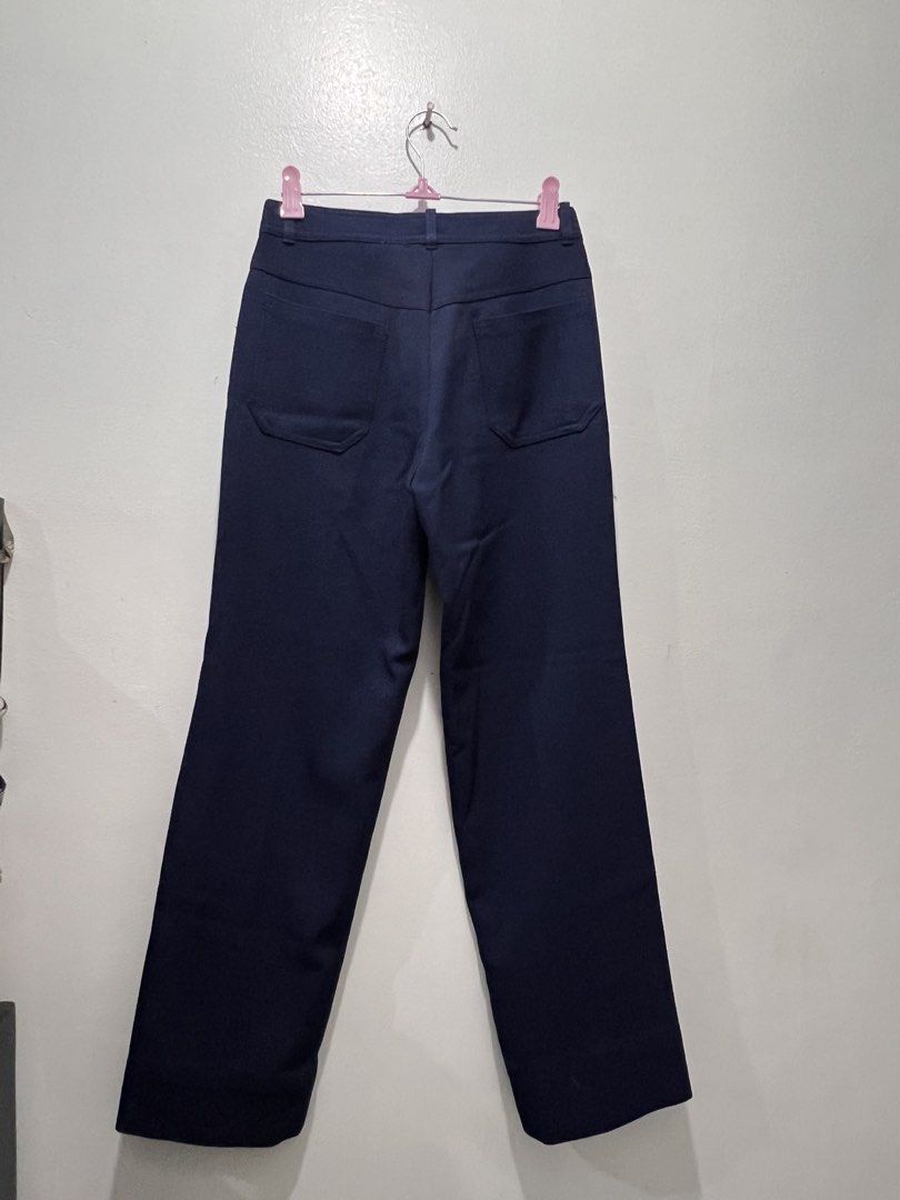 Navy Blue Wide Leg Trousers (Category: Other Bottoms) located in Quezon City. Submitted by vnviloria (Listing ID 1458912401, Image 2). Description: - Navy blue wide-leg trousers - Classic fit - Front button and zip closure - Two back pockets - Versatile for casual or smart casual wear Size 24-25.