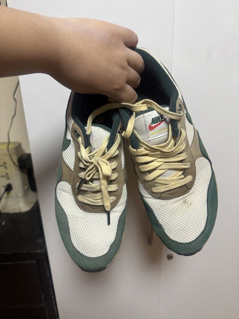 Nike Air Max SYSTM Green (Category: Sneakers) located in Manila. Submitted by quintessesommerset (Listing ID 1458968417, Image 1). Description: - Classic Nike Air Max 1 sneakers, minor stain just recently obtained, can easily be removed - Colorway: Green, brown, and white panels - Materials: Mesh and suede construction - Laces: Light cream color - Perfect for casual everyday wear - Condition: Minor marks on sole and upper, consistent with normal 