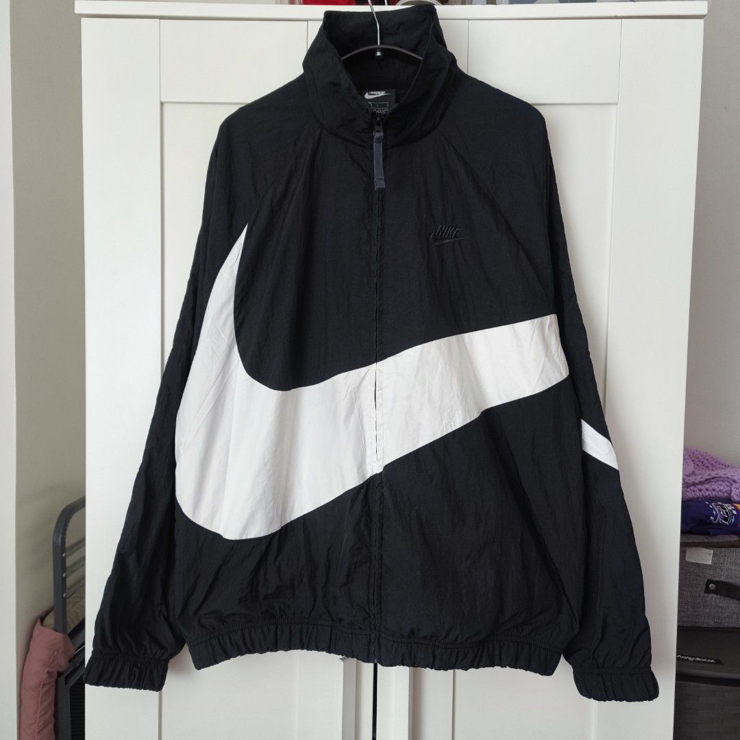 Nike Big Swoosh Windbreaker (Black) (Category: Coats, Jackets and Outerwear) located in Caloocan City. Submitted by thriftdeluxe3305 (Listing ID 1458918232, Image 1). Description: Nike Big Swoosh Windbreaker (Black) Width: 25 Length: 29 Size L on tag --- Color Rate: 10/10 Condition: 9.7/10 (Excellent Condition; small pen marks) *washed and ready to use* --- 3,500php PLUS SHIPPING FEE.