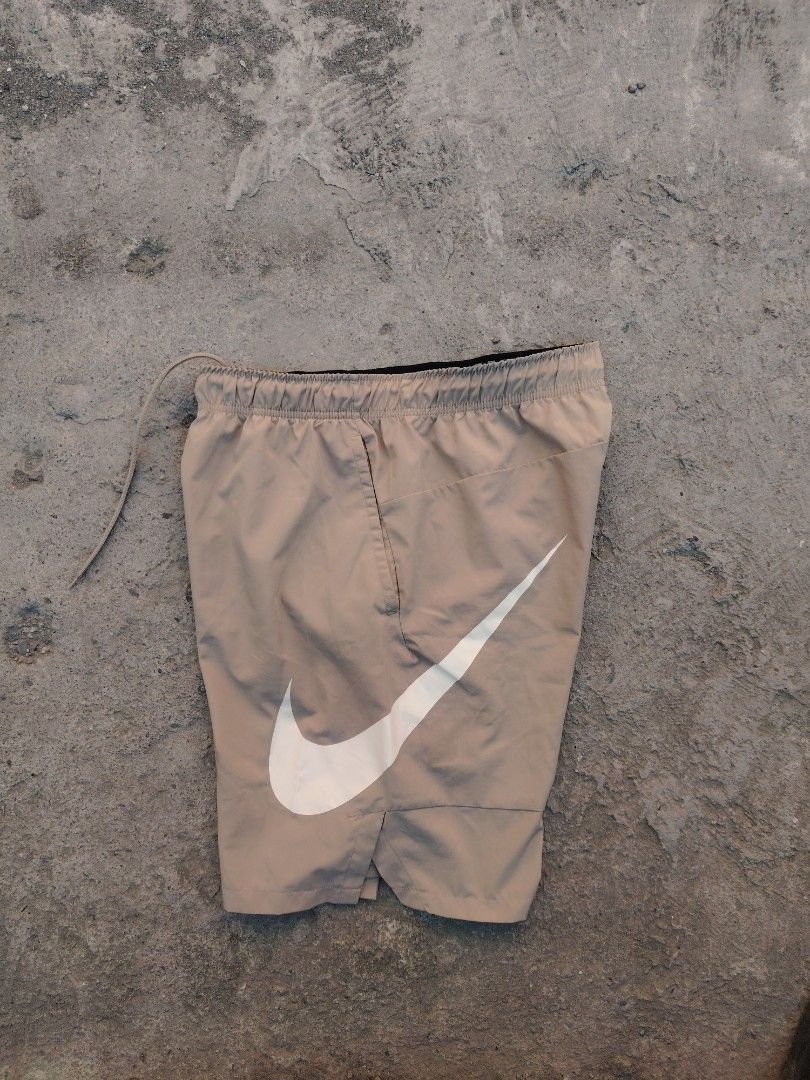 Nike Dri-Fit Shorts Size L Beige (Category: Shorts) located in Calapan. Submitted by thriftopia_12 (Listing ID 1458958010, Image 1). Description: - Beige Nike Dri-Fit Shorts - Size: Large (L) - Elastic waistband with drawstring for a comfortable fit - Convenient pockets - Features a large Nike swoosh logo on one leg and a smaller logo on the other - Made in China.
