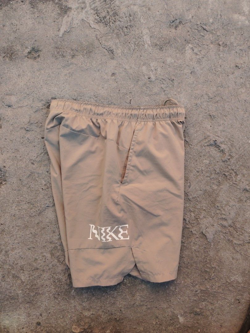 Nike Dri-Fit Shorts Size L Beige (Category: Shorts) located in Calapan. Submitted by thriftopia_12 (Listing ID 1458958010, Image 2). Description: - Beige Nike Dri-Fit Shorts - Size: Large (L) - Elastic waistband with drawstring for a comfortable fit - Convenient pockets - Features a large Nike swoosh logo on one leg and a smaller logo on the other - Made in China.