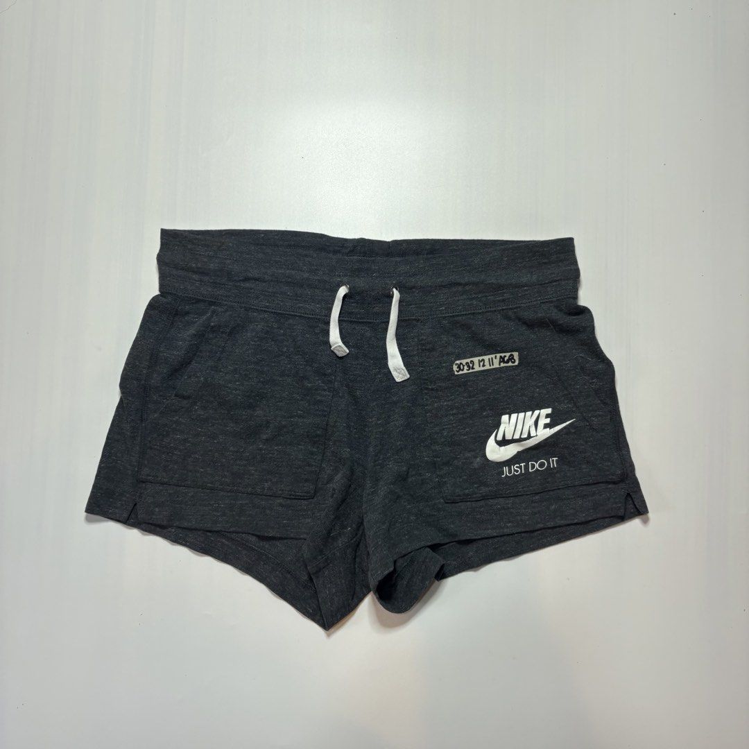 Nike Grey Shorts Size Large (Category: Shorts) located in Baguio. Submitted by cosmogyralfinds (Listing ID 1459050700, Image 3). Description: - Grey Nike Shorts - Size: Large (fits waist 30-32 inches) - Length: 12 inches - Features Nike logo and 'Just Do It' print - Adjustable drawstring waist - Ideal for workouts and casual wear.