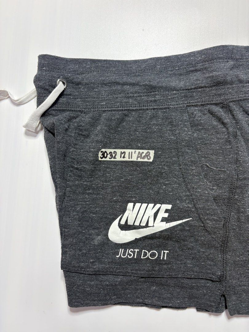 Nike Grey Shorts Size Large (Category: Shorts) located in Baguio. Submitted by cosmogyralfinds (Listing ID 1459050700, Image 2). Description: - Grey Nike Shorts - Size: Large (fits waist 30-32 inches) - Length: 12 inches - Features Nike logo and 'Just Do It' print - Adjustable drawstring waist - Ideal for workouts and casual wear.