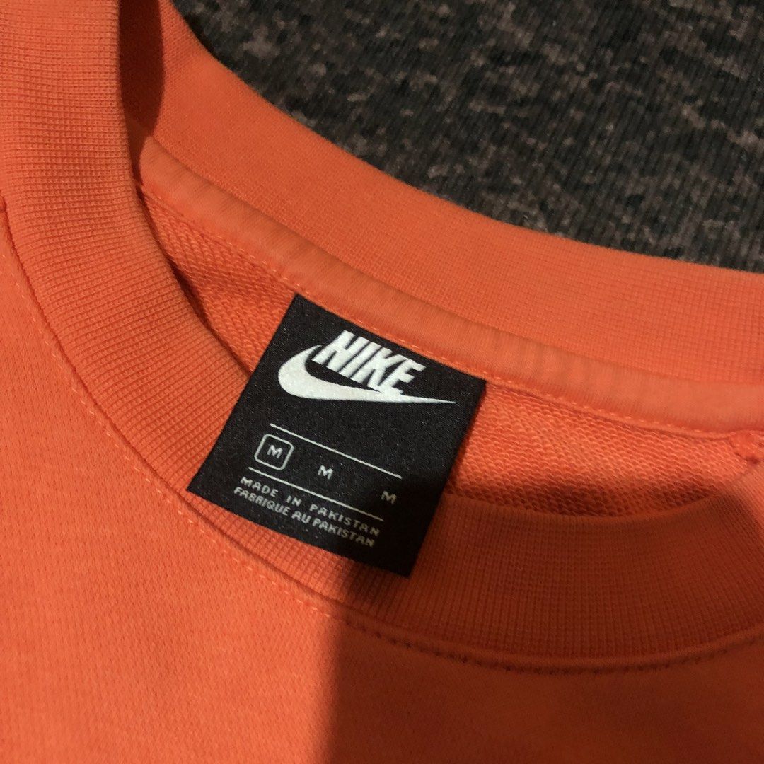 Nike Orange Crewneck Sweatshirt Size M (Category: Coats, Jackets and Outerwear) located in Dasmarinas. Submitted by johnlloydm99208 (Listing ID 1459068624, Image 3). Description: - Orange Nike sweatshirt - Double Nike logo on chest - Peace sign graphic on left sleeve - Made in Pakistan - Tagged size M - Ideal for casual wear.