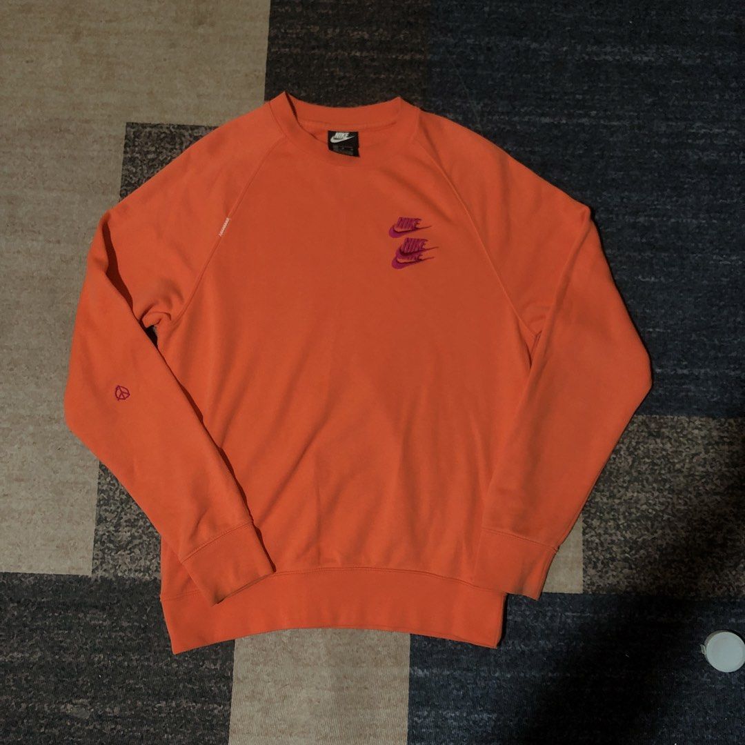 Nike Orange Crewneck Sweatshirt Size M (Category: Coats, Jackets and Outerwear) located in Dasmarinas. Submitted by johnlloydm99208 (Listing ID 1459068624, Image 1). Description: - Orange Nike sweatshirt - Double Nike logo on chest - Peace sign graphic on left sleeve - Made in Pakistan - Tagged size M - Ideal for casual wear.