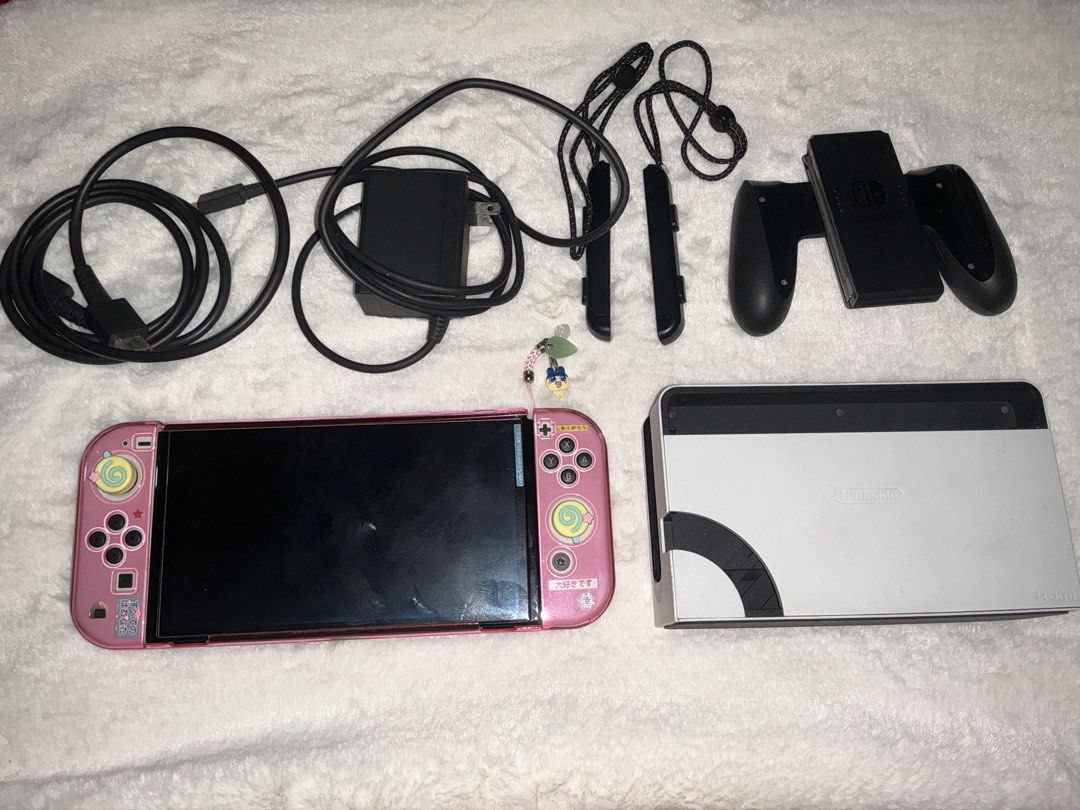 Nintendo Switch OLED (complete) (Category: Nintendo) located in Caloocan City. Submitted by sharjm (Listing ID 1459061764, Image 2). Description: selling my nintendo switch OLED!! Inclusions: Complete accessories pink clear case and thumb grips keychain Unit has no issues like scratches or dents at all. Performance and battery is 10/10, and no stick drifts:)) Rfs: planning to upgrade to ns2 delivery: lalamove/lbc/jnt meetups: around sm grand.