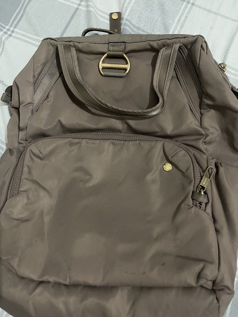 Pacsafe Anti-Theft Backpack Taupe (Category: Backpacks) located in Manila. Submitted by fionanicolas (Listing ID 1459008435, Image 3). Description: - Taupe Pacsafe backpack - Numerous interior and exterior pockets - Main compartment with zippered and slip pockets - Adjustable straps - Gold hardware - Ideal for travel and everyday use.