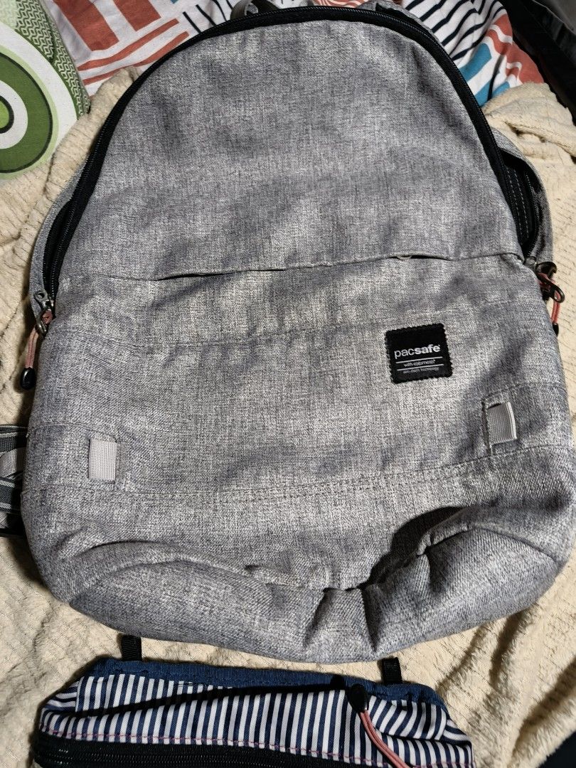 Pacsafe Slingsafe LX400 2 in 1 Backpack (Category: Backpacks) located in Quezon City. Submitted by bagsareus428 (Listing ID 1458950793, Image 2). Description: - Grey Pacsafe backpack 2 in 1 bags ( with detachable body bag /pouch. lightweight anti theft bagsp - Front zip pocket - Main compartment with laptop sleeve and internal pockets - Durable polyester material - Ideal for travel and everyday use - Zippers are in good working condition - Shows 