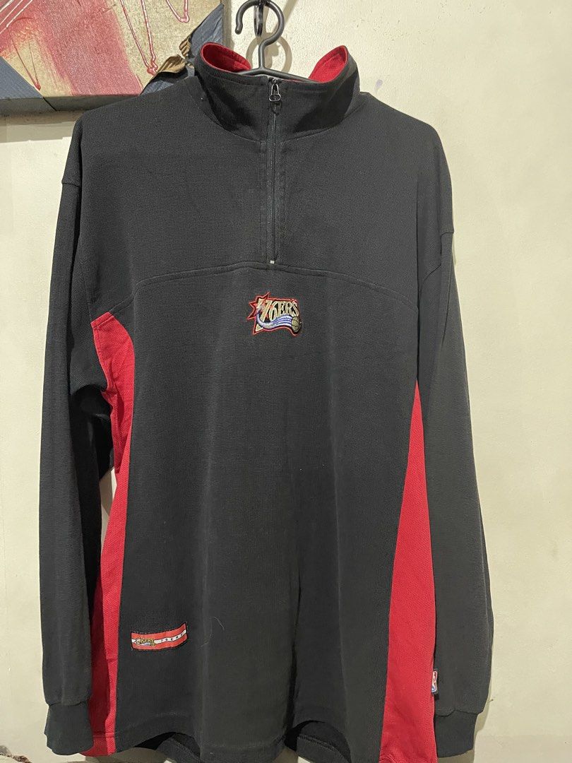 Philadelphia 76ers NBA Quarter Zip Pullover Sweatshirt (Category: Coats, Jackets and Outerwear) located in Mandaluyong City. Submitted by mark2pac (Listing ID 1458956063, Image 1). Description: - Black and red quarter zip pullover sweatshirt - Features embroidered Philadelphia 76ers logo on the chest - Includes a smaller 76ers logo patch on the lower left side - NBA branding visible on the inner collar - Small NBA logo tag on the side - Ideal for