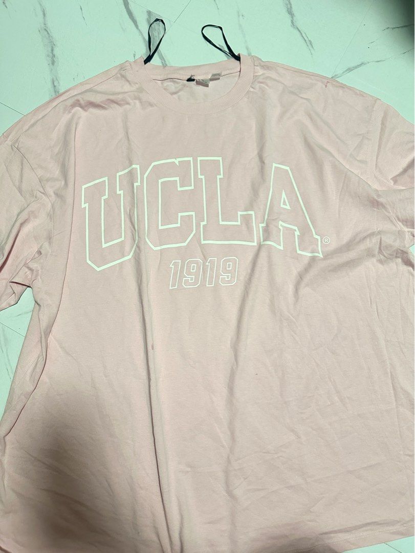 Pink UCLA 1919 T-Shirt (Category: Shirts) located in Manila. Submitted by tipidfinds888 (Listing ID 1459029743, Image 1). Description: - Light pink t-shirt with UCLA 1919 graphic print - Crew neck, short sleeves - Comfortable, casual style.