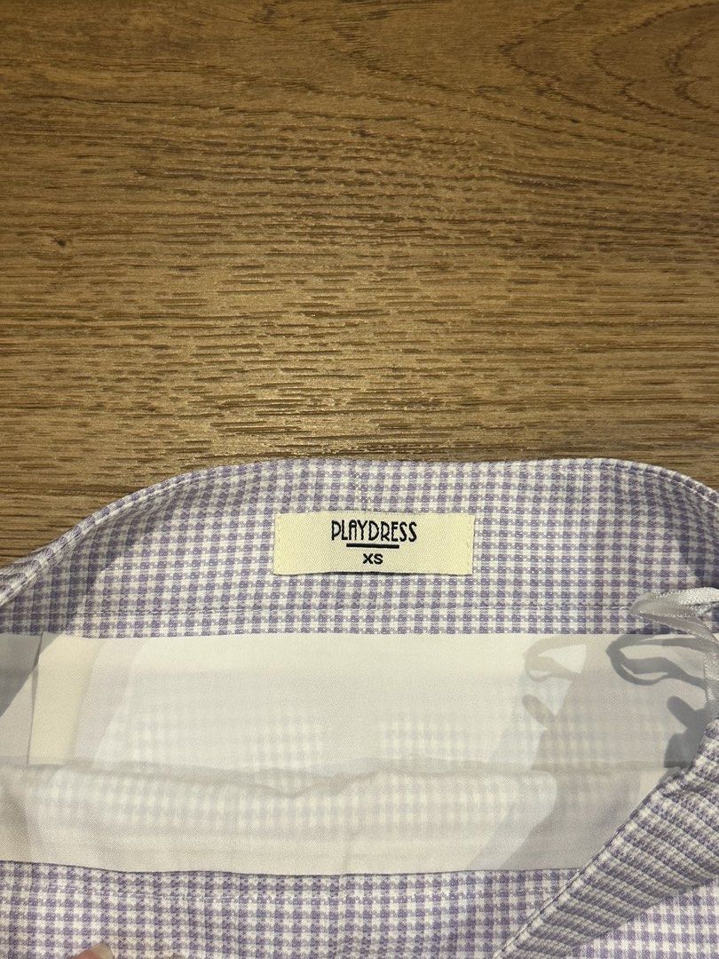 PLAYDRESS Gingham Button Front Mini Skirt XS (Category: Skirts) located in San Juan City. Submitted by yanna_888 (Listing ID 1458964980, Image 2). Description: - Brand: PLAYDRESS - Style: Gingham mini skirt - Features: Button-front design - Estimated Size: XS - Versatile: Great for casual wear or dressing up.