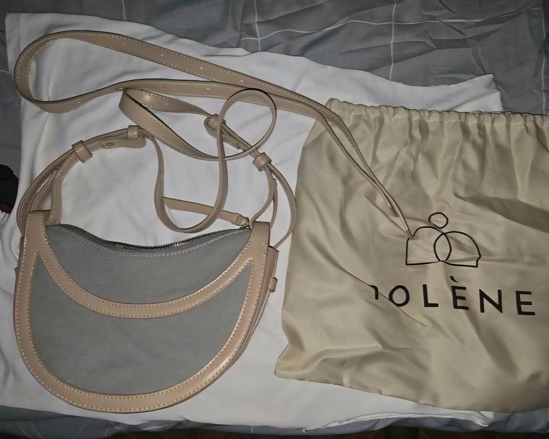 Polene Bag with Dustbag (Category: Luxury Bags & Wallets) located in Marikina City. Submitted by mariamahmaaaad (Listing ID 1458913384, Image 1). Description: - Polene crescent bag - Grey canvas body with light beige leather trim - Adjustable strap for comfortable wear - Includes original dustbag - Ideal for everyday use.
