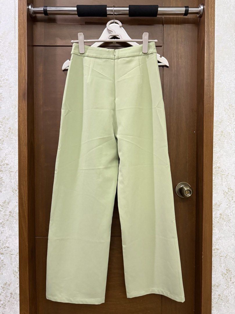 Pomelo Light Green High Waisted Trouser Pants (Category: Other Bottoms) located in Tarlac. Submitted by samdeclutters_ (Listing ID 1458947687, Image 3). Description: - Size: S - Color: Light Sage Green - Length: 39” - Design: High waist cut, wide leg silhouette, tortoiseshell button accents - Suited for smart casual wear or elevated office attire.