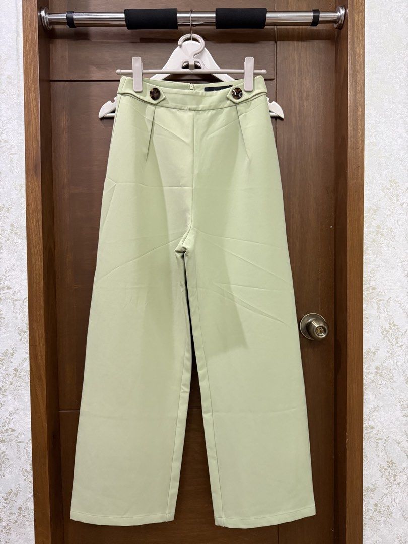 Pomelo Light Green High Waisted Trouser Pants (Category: Other Bottoms) located in Tarlac. Submitted by samdeclutters_ (Listing ID 1458947687, Image 2). Description: - Size: S - Color: Light Sage Green - Length: 39” - Design: High waist cut, wide leg silhouette, tortoiseshell button accents - Suited for smart casual wear or elevated office attire.
