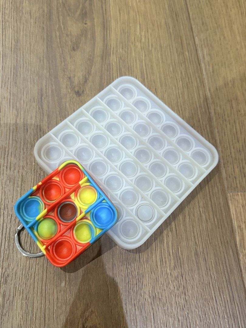 Pop It Fidget Toys - Square and Keychain Set (Category: Kids Toys) located in San Juan City. Submitted by yanna_888 (Listing ID 1459007058, Image 1). Description: - Set of 2 Pop It fidget toys - Large white square Pop It - Small colorful square keychain Pop It - Ideal for stress relief and fun - Portable and easy to carry.