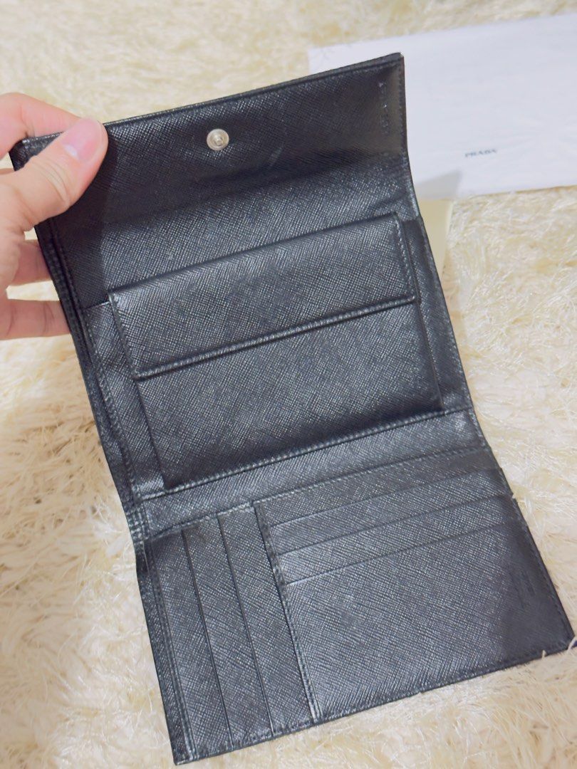 Prada Black Nylon Bi-fold Wallet with Box and Authenticity Card (Category: Luxury Bags & Wallets) located in Manila. Submitted by misusoh (Listing ID 1458977492, Image 3). Description: - Authentic Prada wallet - Black nylon exterior with iconic Prada logo - Black leather interior with multiple card slots and compartments - Includes original Prada box, dust bag, and authenticity card - Ideal for everyday use.