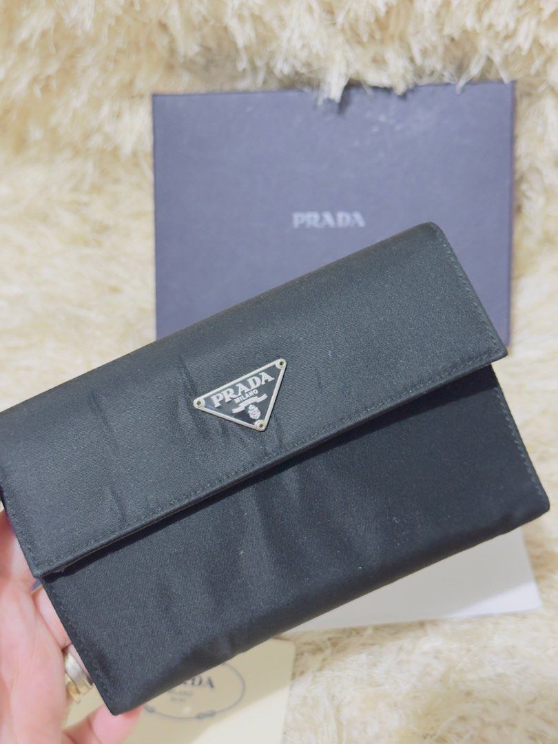 Prada Black Nylon Bi-fold Wallet with Box and Authenticity Card (Category: Luxury Bags & Wallets) located in Manila. Submitted by misusoh (Listing ID 1458977492, Image 2). Description: - Authentic Prada wallet - Black nylon exterior with iconic Prada logo - Black leather interior with multiple card slots and compartments - Includes original Prada box, dust bag, and authenticity card - Ideal for everyday use.