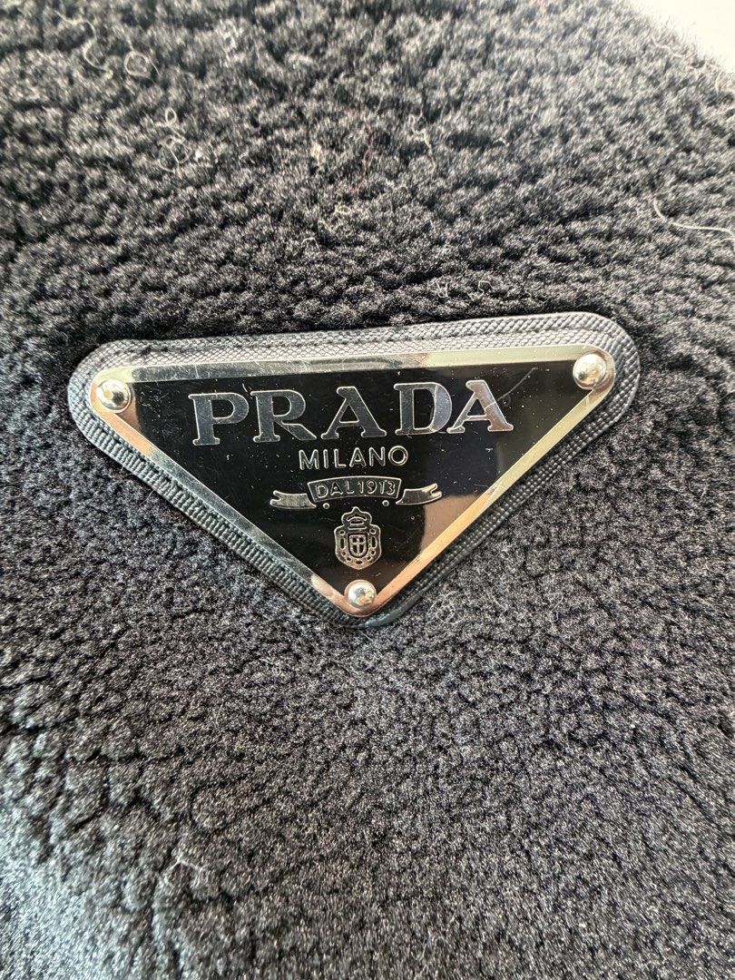 PRADA Fleece Teddy Bomber Jacket (Size M) – Black Enamel Triangle Logo (Category: Luxury Apparel) located in San Juan City. Submitted by vc828 (Listing ID 1458905580, Image 2). Description: PRADA Re-Nylon Fleece Teddy Bomber Jacket (Size M) – Black Enamel Triangle Logo Prada heavyweight sherpa fleece zip bomber jacket in black. Features the iconic Saffiano leather and metal enamel triangle logo on the chest, a large knitted Prada Milano crest mot