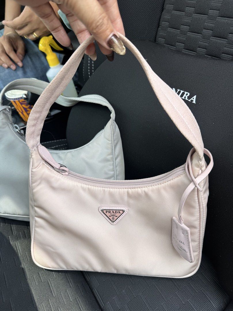 Prada Nylon Shoulder Bag - Pink & Grey (Category: Luxury Bags & Wallets) located in Quezon City. Submitted by derill_shop (Listing ID 1458956765, Image 3). Description: - Two Prada Nylon Shoulder Bags available. - Colors: Light Pink and Light Grey. - Includes original dust bags for both. - Ideal for everyday wear. - Classic and iconic Prada design..