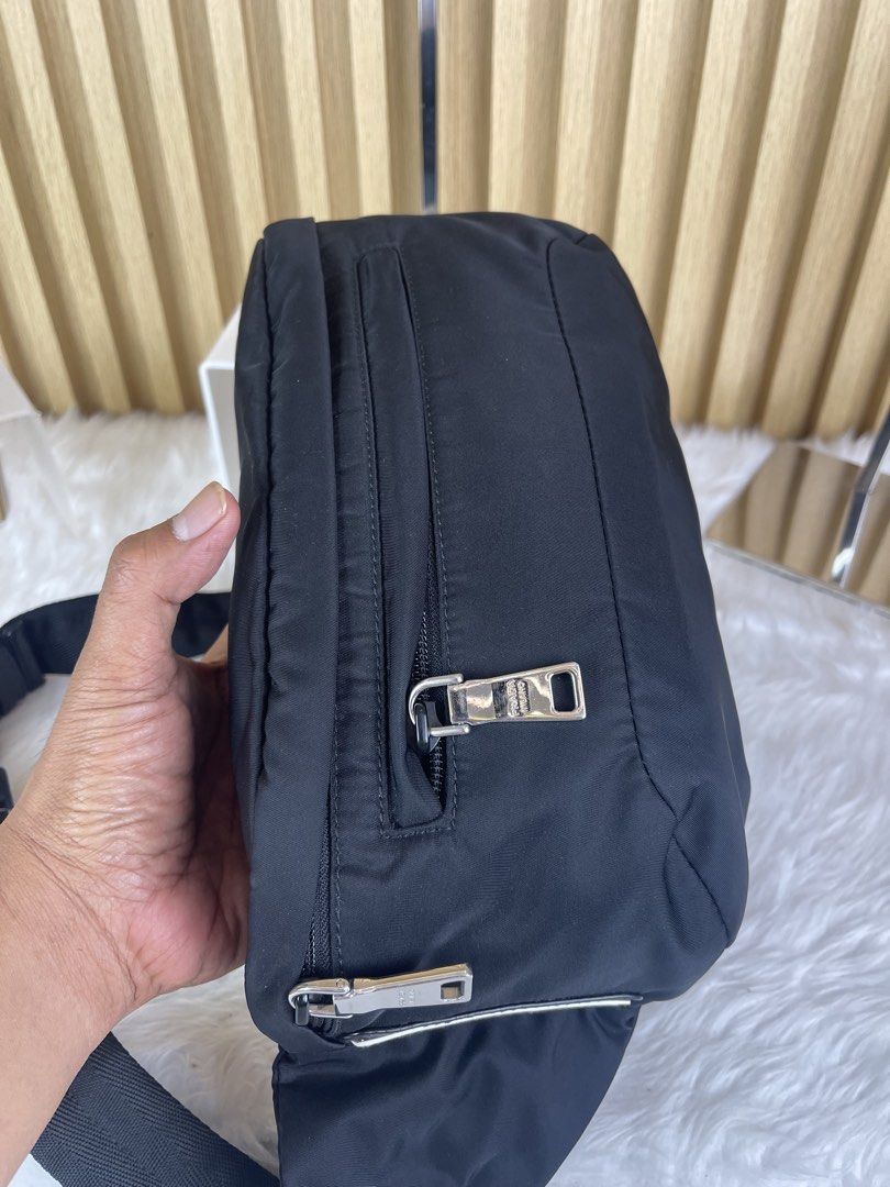 Prada Nylon Waist Bag Black (Category: Luxury Bags & Wallets) located in Manila. Submitted by cuaresmahajji (Listing ID 1459060748, Image 3). Description: - Authentic Prada Nylon Waist Bag - Color: Black - Adjustable strap with silver buckle - Multiple zippered compartments - Classic Prada logo detail on front - Ideal for everyday use and travel - Versatile and stylish.