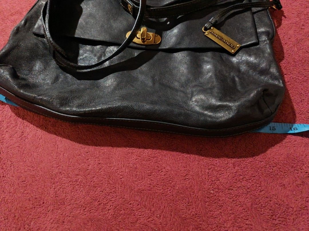 RABEANCO Black Leather Shoulder Bag (Category: Luxury Bags & Wallets) located in Manila. Submitted by jasminejehsu (Listing ID 1458893997, Image 3). Description: - Brand: Rabbanco - Color: Black - Material: Genuine Leather - Closure: Turn-lock - Strap: Adjustable shoulder strap - Hardware: Gold-tone - Features: Soft leather texture, spacious interior - Ideal for: Everyday use.