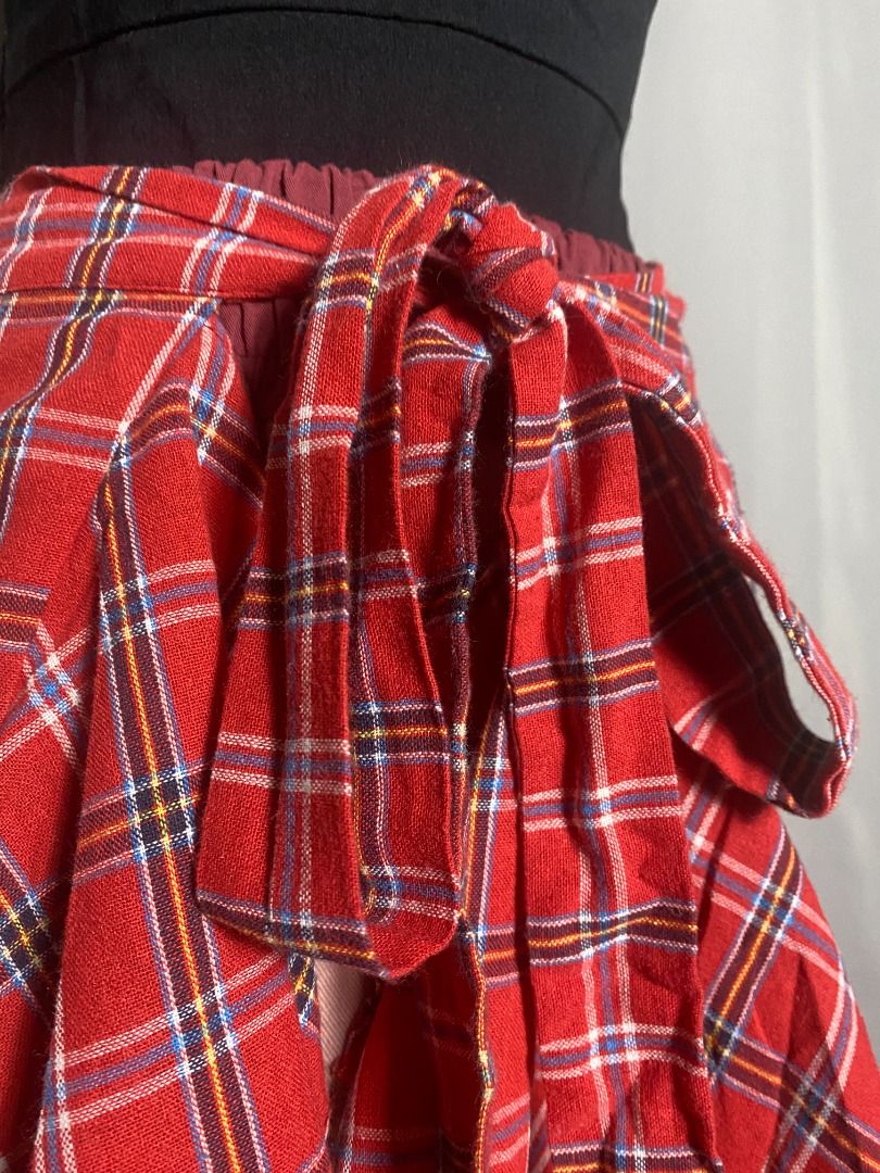 Red plaid asymmetrical wrap skirt overlay (Category: Other Bottoms) located in Las Pinas. Submitted by ipickyou (Listing ID 1459049029, Image 3). Description: Unwashed Condition: 10/10 𝗠𝗲𝗮𝘀𝘂𝗿𝗲𝗺𝗲𝗻𝘁𝘀 𝘄𝗵𝗲𝗻 𝗹𝗮𝗶𝗱 𝗳𝗹𝗮𝘁: -Waist: 14-17” -Length: 20”.