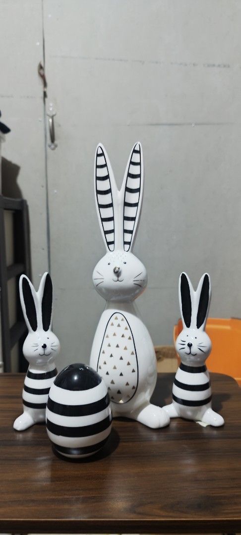 Set of 3 Easter Bunny Figurines with Egg (Category: Figurines & Statues) located in Manila. Submitted by silverwhale_cafa21 (Listing ID 1459043508, Image 1). Description: - Set includes 3 ceramic bunny figurines and 1 decorative egg. - All pieces feature black and white striped patterns. - Large bunny has unique gold triangle accents on its belly. - Ideal for Easter celebrations or as charming home decor any time of year. - Perfect for displaying
