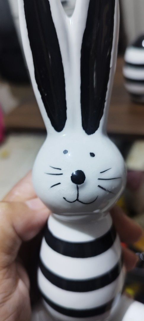 Set of 3 Easter Bunny Figurines with Egg (Category: Figurines & Statues) located in Manila. Submitted by silverwhale_cafa21 (Listing ID 1459043508, Image 2). Description: - Set includes 3 ceramic bunny figurines and 1 decorative egg. - All pieces feature black and white striped patterns. - Large bunny has unique gold triangle accents on its belly. - Ideal for Easter celebrations or as charming home decor any time of year. - Perfect for displaying