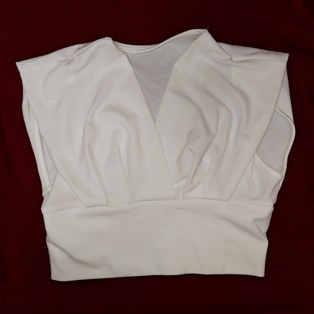 SHEIN White V-Neck Cropped Top (Category: Blouses) located in San Fernando. Submitted by decluttwv (Listing ID 1459040636, Image 1). Description: - White cropped top from SHEIN - V-neck design - Cinched waist for a flattering fit - Sleeveless with cute cap sleeves - Comfortable polyester and elastane blend - Versatile for casual outings or dressing up.