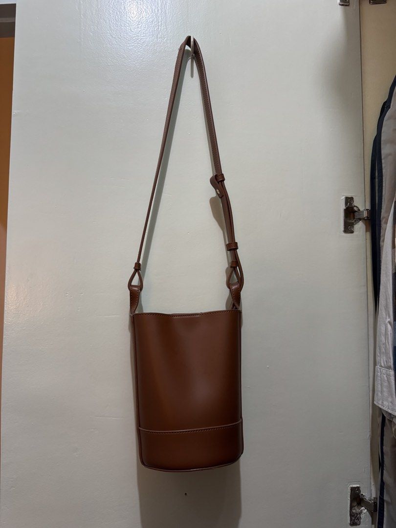 SHOOPEN Small Brown Bucket Bag (Category: Shoulder Bags) located in San Juan City. Submitted by sfvr. (Listing ID 1459001070, Image 1). Description: - Brand: SHOOPEN - Style: Bucket Bag - Color: Brown - Material: Faux Leather - Closure: Snap Button (inside) - Strap: Adjustable - Design: Simple and Classic - Usage: Ideal for daily use, fits essentials Never used :).