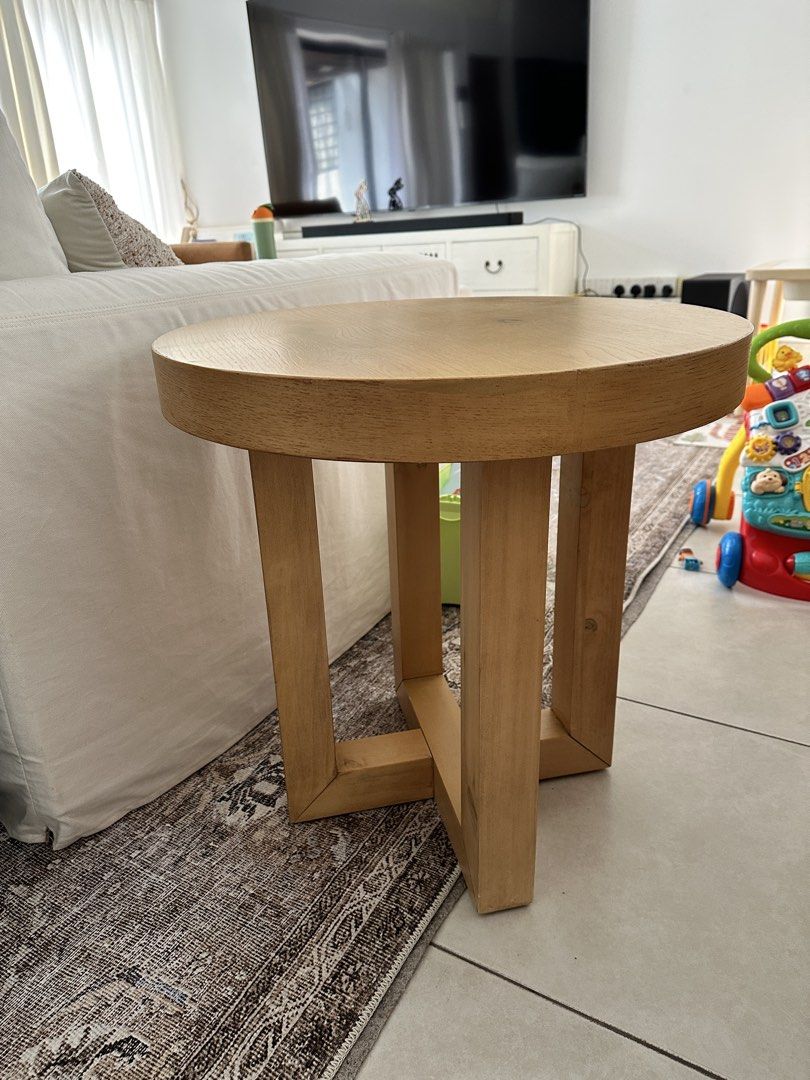 Solid Wood Round Side Table (Category: Tables & Sets) located in Singapore. Submitted by nickywicky (Listing ID 1458955684, Image 2). Description: - Solid wood construction for durability. - Natural wood grain finish adds warmth. - Four sturdy legs with cross-brace for enhanced stability. - Versatile use as a bedside table or accent piece. - Complements both modern and rustic interior designs. - Dimensions: Approximately 57cm tall and 56cm in dia