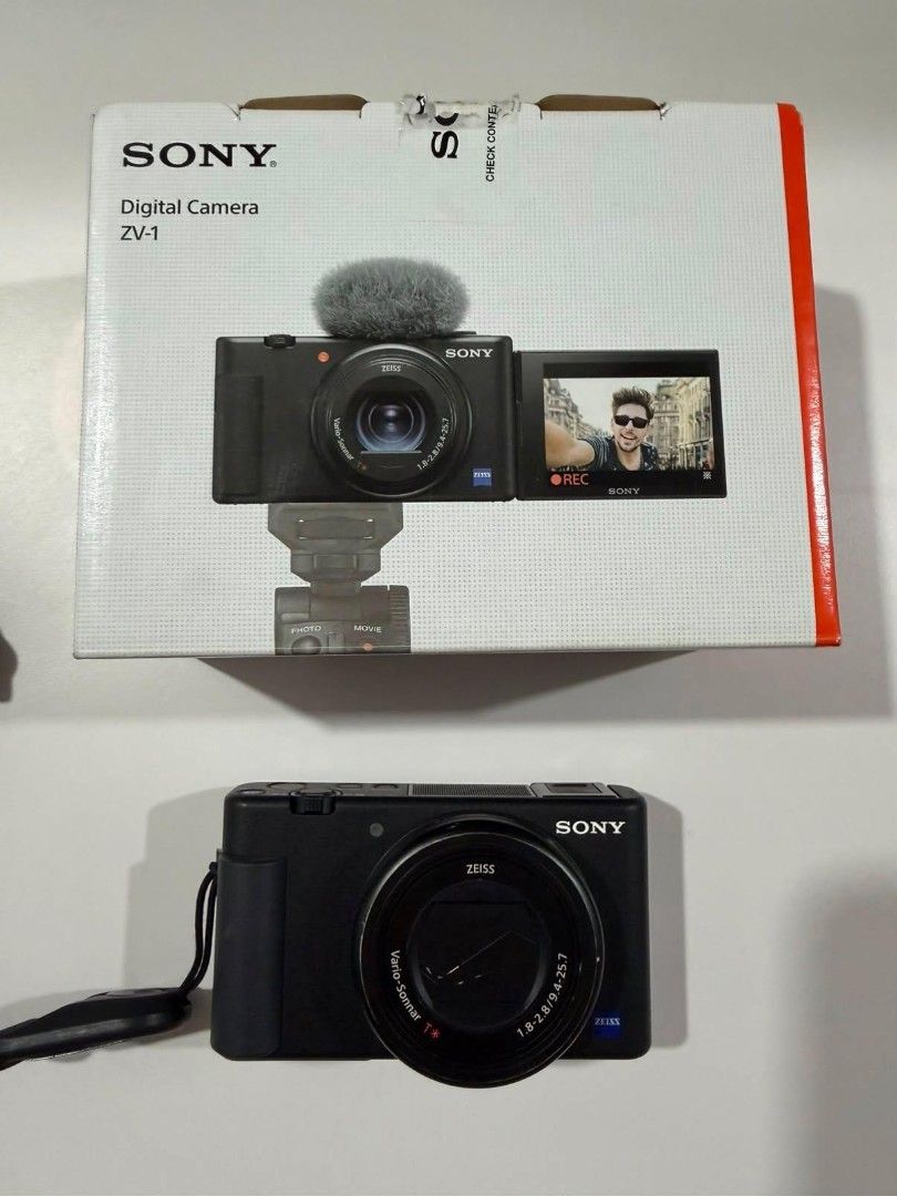 Sony ZV-1 Digital Camera (Category: Cameras) located in Paranaque City. Submitted by jamsx73 (Listing ID 1458986245, Image 1). Description: - Lady owned - Battery, wire charger, and muff included (these are what you get when you purchase it brand new) - Free Sony bluetooth shooting grip (orig price at 6k) and free Ulanzi flash - Has external signs of usage (natanggal na onti yung black paint as seen in 3rd photo) - No issues - Pm for sample video