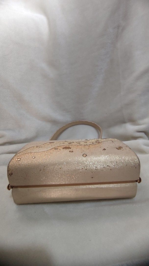 Sparkly Rose Gold Clutch Bag with Handle (Category: Clutches) located in Manila. Submitted by annetteasi22390 (Listing ID 1458950804, Image 2). Description: - Cute sparkly clutch bag - Rose gold color with textured pattern - Features a small handle - Interior card slots for convenience - Ideal for parties and special occasions - Approximately 8 inches wide.