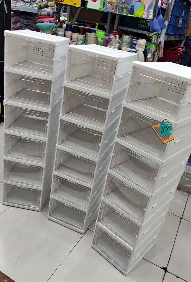 Stackable Clear Shoe Storage Boxes Organizer (Category: Storage Boxes & Baskets) located in Manila. Submitted by chaionlineshop (Listing ID 1459016709, Image 2). Description: - Stackable Shoe Storage Boxes - Clear with White Frame - Easy to Assemble and Stack - Perfect for Sneakers, Heels, and More - Dimensions: 34.5cm x 25.5cm x 19.5cm - Space-Saving Design - Keeps Shoes Tidy and Dust-Free.