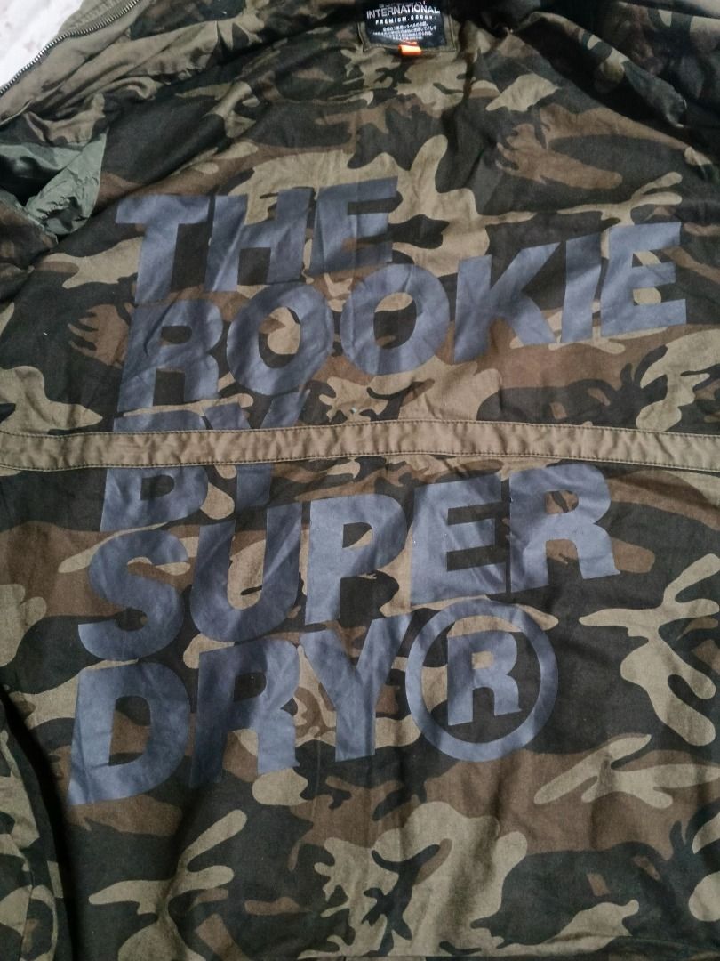 Superdry International Military Jacket (Category: Coats, Jackets and Outerwear) located in Caloocan City. Submitted by nebs_seller (Listing ID 1458894807, Image 2). Description: - Superdry International Jacket - Color: Olive Green - Size: 2XL - Camouflage lining with 'The Rookie Super Dry' print - Hooded design - Multiple pockets - Ideal for casual wear.