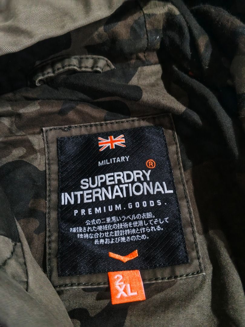 Superdry International Military Jacket (Category: Coats, Jackets and Outerwear) located in Caloocan City. Submitted by nebs_seller (Listing ID 1458894807, Image 3). Description: - Superdry International Jacket - Color: Olive Green - Size: 2XL - Camouflage lining with 'The Rookie Super Dry' print - Hooded design - Multiple pockets - Ideal for casual wear.