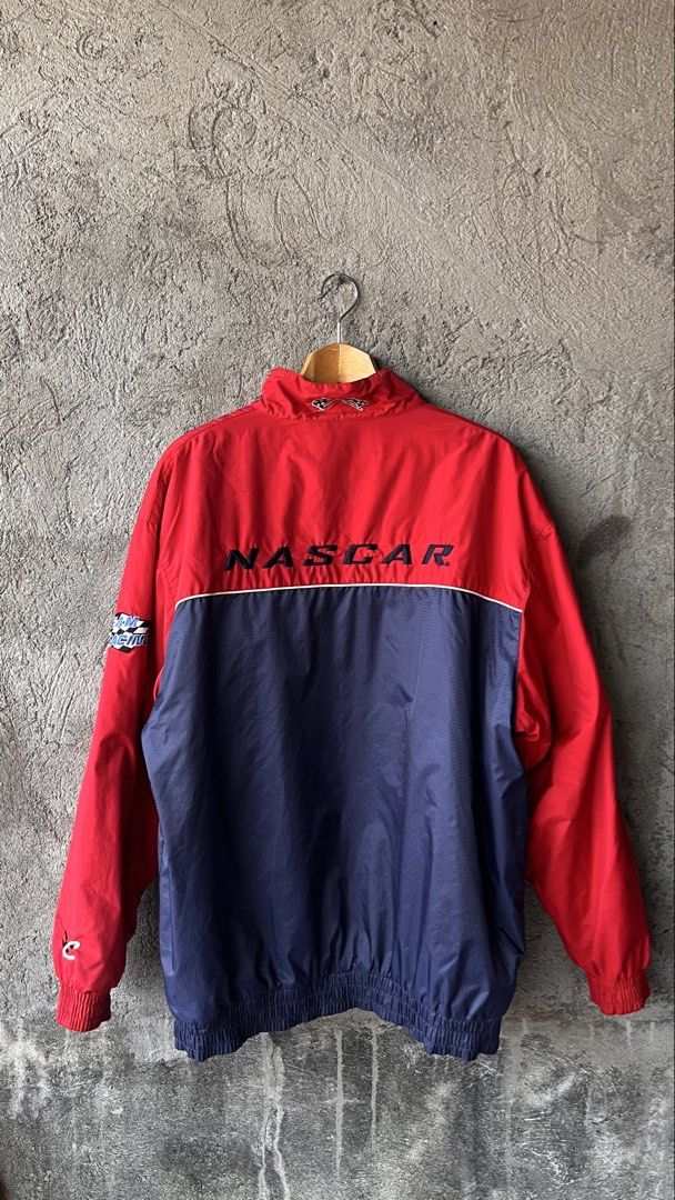 Team NASCAR Racing Jacket Red Blue Windbreaker (Category: Coats, Jackets and Outerwear) located in Cabuyao City. Submitted by bulandos (Listing ID 1459014441, Image 2). Description: - Cool red and blue Team NASCAR racing jacket. - Embroidered 'Team NASCAR' on the front. - 'NASCAR' logo embroidered on the back. - 'Team Racing' and checkered flag logo on the sleeve. - Features elastic cuffs and hem for a comfortable fit. - Please note: there are a 