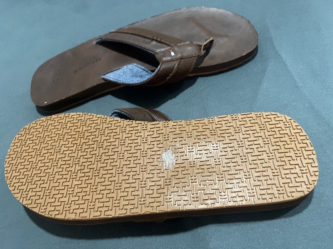 Tommy Hilfiger Brown Leather Flip-Flops Size 11 (Category: Slippers and slides) located in Muntinlupa City. Submitted by cerealrn (Listing ID 1458905673, Image 2). Description: - Brand: Tommy Hilfiger - Color: Brown - Material: Leather straps with denim-like fabric lining - Size: 11 - Sole: Good grip pattern - Style: Casual wear.