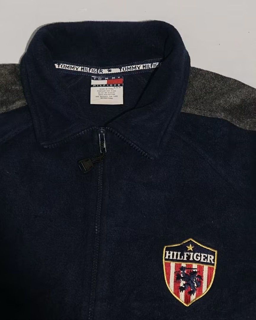 Tommy Hilfiger Fleece Jacket Navy Blue (Category: Coats, Jackets and Outerwear) located in Manila. Submitted by mariel_loise (Listing ID 1458986031, Image 2). Description: - Cool Tommy Hilfiger fleece jacket - Navy blue with grey sleeves - Tommy Hilfiger logo on the sleeve - Shield logo on the chest - Drawstring at the bottom hem - Great for casual wear -Dimes 22x28 can fil to XL.