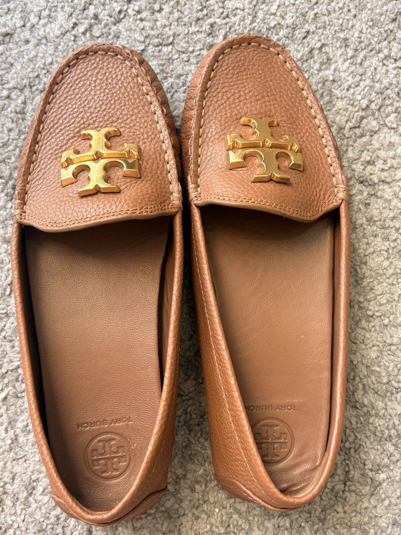 Tory Burch Brown Leather Driving Moccasins (Category: Loafers) located in Pasay City. Submitted by ilovektinx21 (Listing ID 1459020759, Image 1). Description: - Classic Tory Burch driving moccasins - Made from soft brown leather - Features gold Tory Burch logo hardware - Embossed Tory Burch logo on insoles - Comfortable and stylish for everyday wear - A versatile addition to any wardrobe.