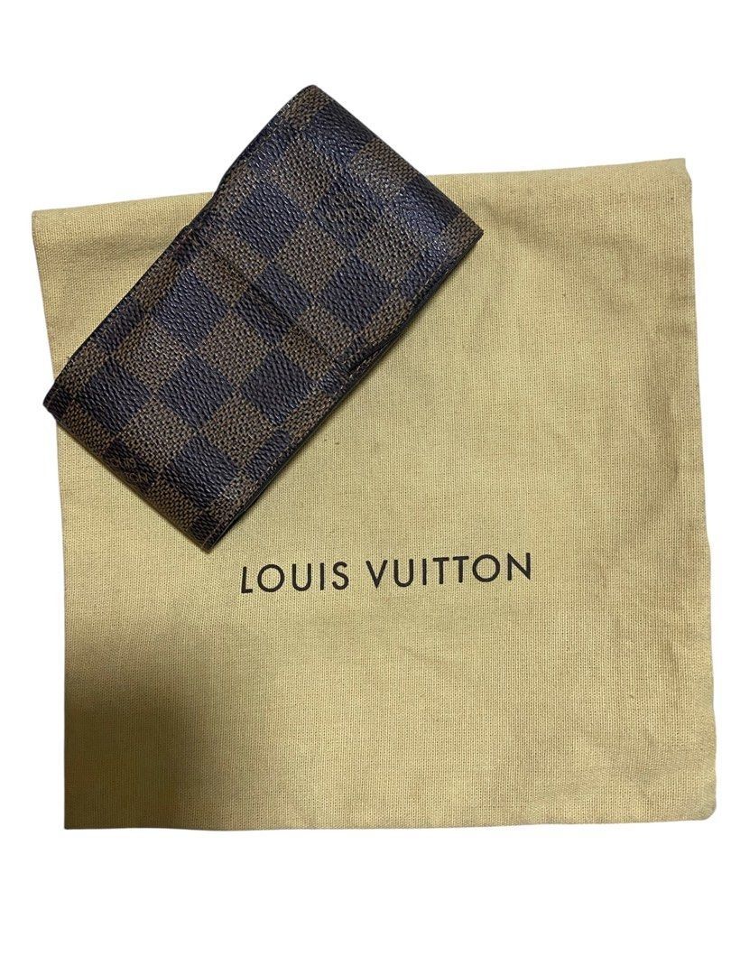 Vintage Louis Vuitton Damier Ebene Cigarette Case. (Category: Luxury Bags & Wallets) located in Quezon City. Submitted by carlos132 (Listing ID 1458981697, Image 1). Description: Authentic Louis Vuitton wallet in Damier Ebene pattern. Features a brown and dark brown checkered design. Includes a dust bag with the Louis Vuitton logo. The interior is a solid brown color..