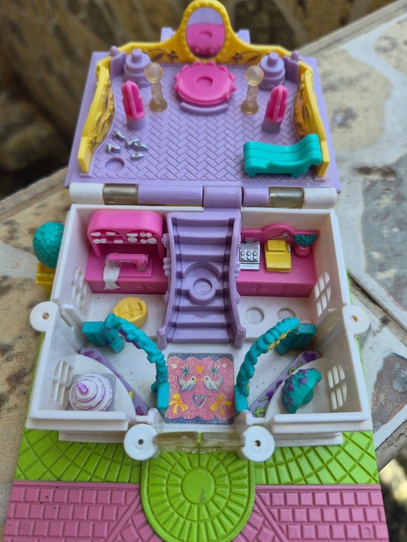 Vintage Polly Pocket Compact House Toy (Category: Kids Toys) located in Antipolo. Submitted by prinsesa_dianne (Listing ID 1458902017, Image 3). Description: - Adorable compact house playset - Opens to reveal tiny rooms and furniture - Comes with accessories like a bed, table, and chairs - Encourages imaginative play - Folds up for easy storage and portability - Ideal for collectors or kids who enjoy small toys.