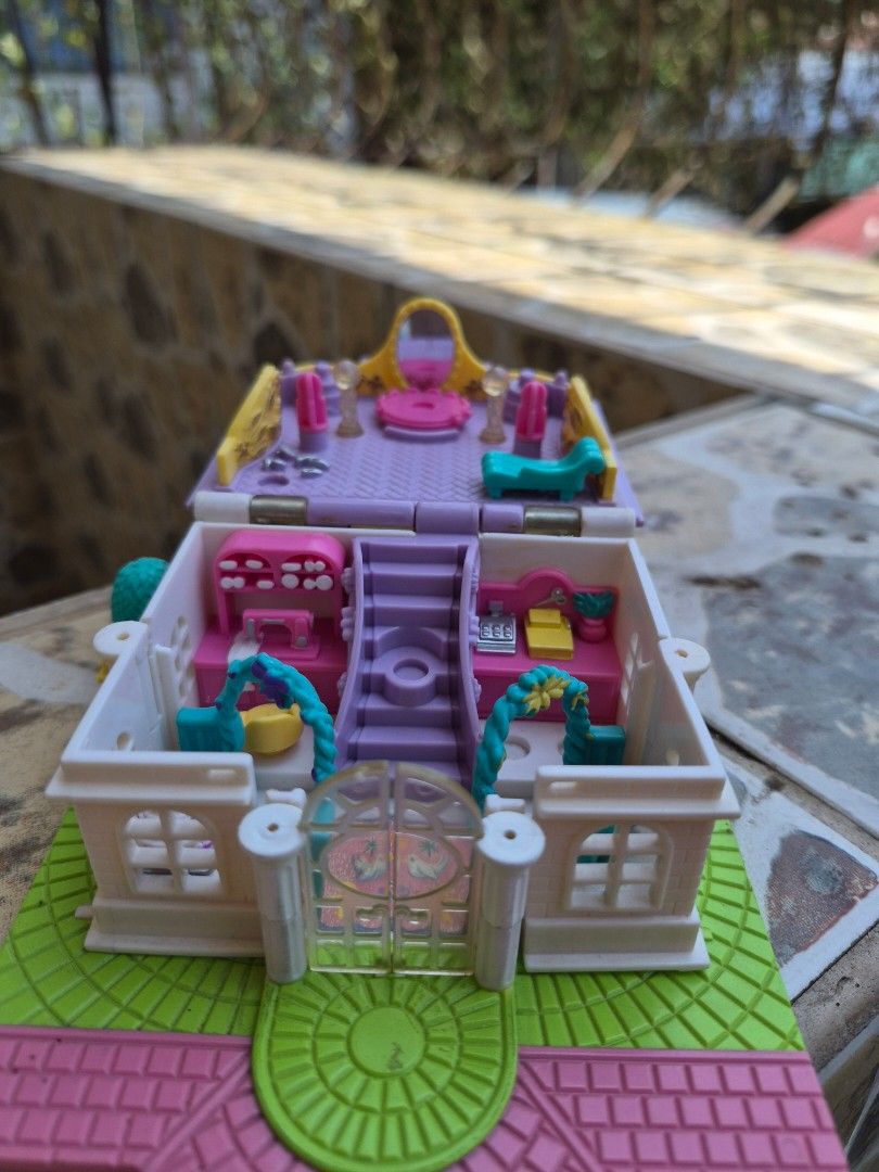 Vintage Polly Pocket Compact House Toy (Category: Kids Toys) located in Antipolo. Submitted by prinsesa_dianne (Listing ID 1458902017, Image 2). Description: - Adorable compact house playset - Opens to reveal tiny rooms and furniture - Comes with accessories like a bed, table, and chairs - Encourages imaginative play - Folds up for easy storage and portability - Ideal for collectors or kids who enjoy small toys.